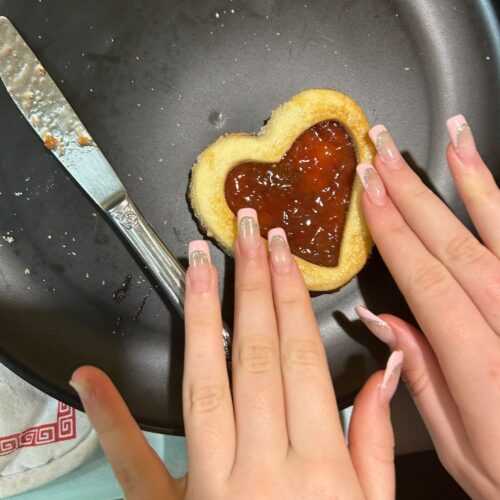 Spread jelly on cookie
